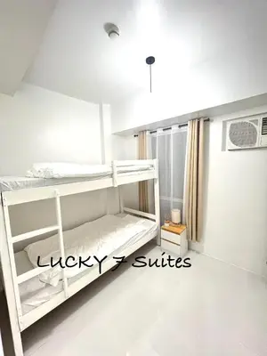 a white bunk bed in a white room at LUCKY 7 Suites in Manila
