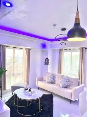 a living room with a couch and a table at LUCKY 7 Suites in Manila
