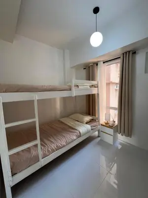 a room with two bunk beds and a window at LUCKY 7 Suites in Manila