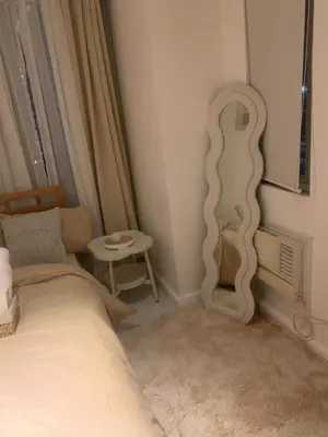 a bedroom with a bed and a mirror on the wall at Oveecation Suites Positano Tower in Manila