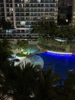 a view of a swimming pool at night at Oveecation Suites Positano Tower in Manila