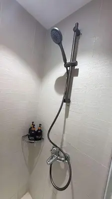 a shower with a shower head in a bathroom at Oveecation Suites Positano Smarthome in Manila