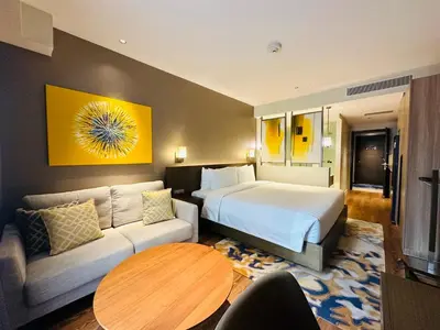 a hotel room with a bed and a couch at Hotel Residences near Makati in Manila