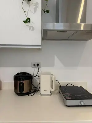 a kitchen counter with a toaster and a slow cooker at Dwell in Manila