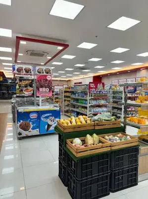 a grocery store aisle with fruits and vegetables on display at Prime End Sunset View Unit in Makati in Manila