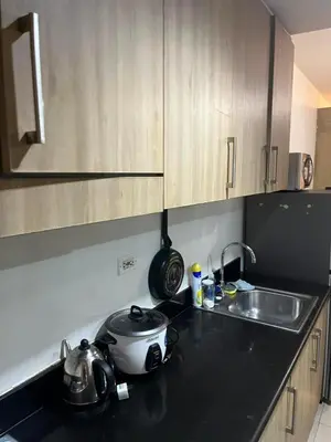 a kitchen counter with a tea pot and a sink at Shore Family Suite 2 beds for 4 pax TV Netflix WiFi Near MOA NAIA 9116 in Manila