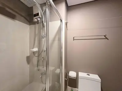 a bathroom with a glass shower and a toilet at 1BR Condotel with Balcony at SM Light Residences #LT10 in Manila