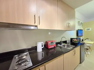 a kitchen with a counter with a toaster and a sink at 1BR Condotel with Balcony at SM Light Residences #LT11 in Manila
