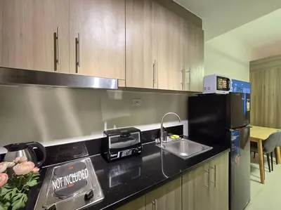 a kitchen with a sink and a counter top at 1BR Condotel with Balcony at FAME Residences #FM62 in Manila