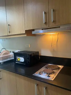 a kitchen with a counter top with a toaster oven at P3K Shell Staycation in Manila