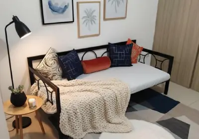 a bed with a blanket on it in a room at Heart of Mall of Asia - Aseana Pasay in Manila