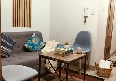 a living room with a couch and a table at Heart of Mall of Asia - Aseana Pasay in Manila