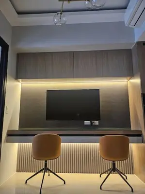 a room with two chairs and a flat screen tv at Luxury Apartment at Park Mckinley West suite 2 in Manila