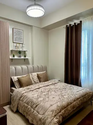 a bedroom with a large bed and a window at The Verdin in General Trias