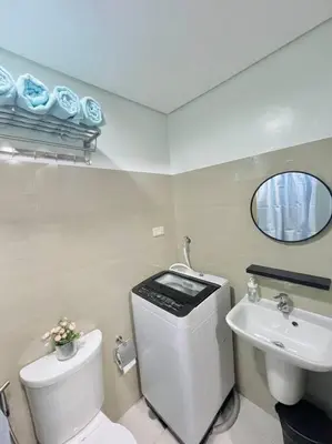 a bathroom with a toilet and a sink and a mirror at Ocean Room 677 Shore 2 Tower 3 MOA Complex, Pasay City in Manila