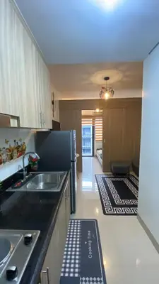 a kitchen with a sink and a refrigerator at CASA ROSITA Staycation by 3MR in Manila