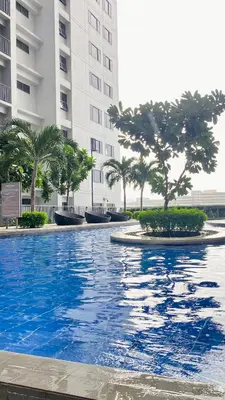 a large swimming pool in front of a building at CASA ROSITA Staycation by 3MR in Manila