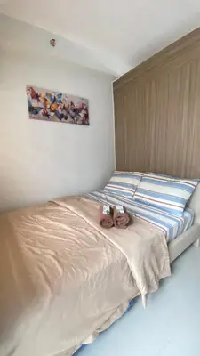 a bed with two stuffed animals sitting on it at CASA ROSITA Staycation by 3MR in Manila