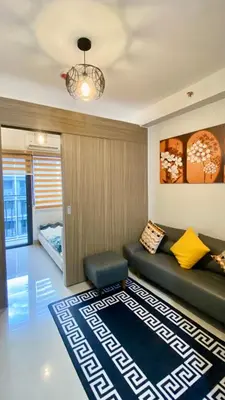 a living room with a couch and a rug at CASA ROSITA Staycation by 3MR in Manila