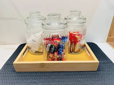 three glass jars filled with candy in a wooden tray at MUJI TOWNHOUSE SUITE in Central Makati BILLIARDS, KTV in Manila