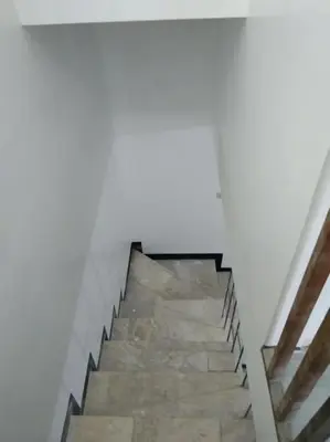 a staircase in a building with a white wall at 2BR ENTIRE Familyhome near NAIA,MOA,BGC in Manila