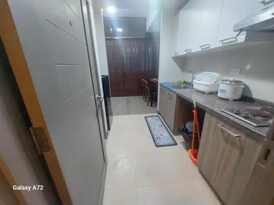 a small kitchen with a counter and a refrigerator at Ezekiel's Suites in Manila