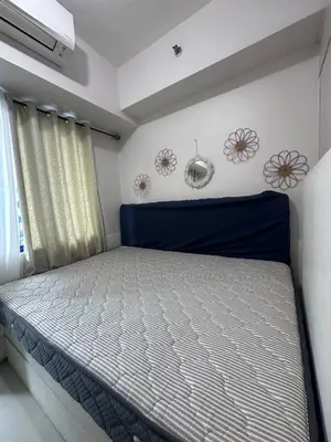 a bedroom with a bed with a blue and white mattress at Sea Residences Tower D, by Richnells in Manila