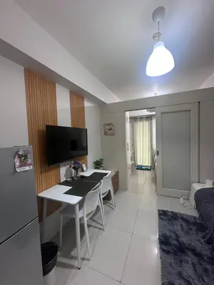 a kitchen and living room with a desk and a room at Sea Residences Tower D, by Richnells in Manila