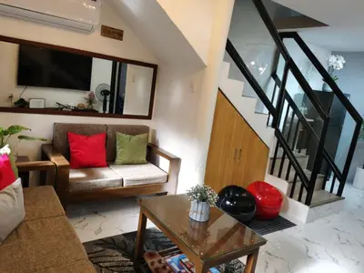 a living room with a couch and a table at Samong Transient House in Imus
