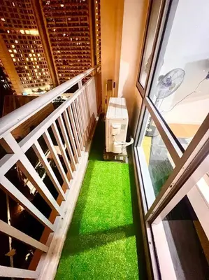 a balcony with a green floor and a window at Rockwell View Acqua Iguazu Tower 17th flr Mandaluyong-Makati 1BR in Manila