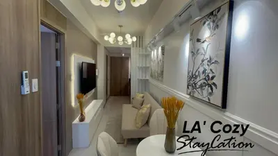 a living room with a couch and a table at Flat in Pasay-Coast Residences in Manila