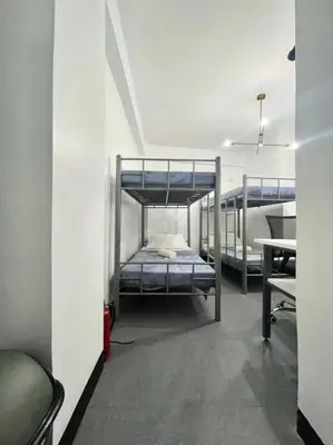 a room with two bunk beds and a desk at Cedar House in Manila