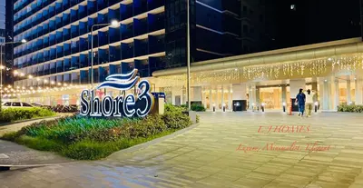 a large building with a sign in front of it at EJ Homes - Shore 3 Residences in Manila