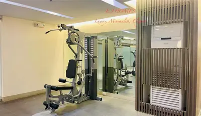 a gym with several tread machines in a room at EJ Homes - Shore 3 Residences in Manila