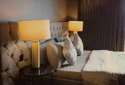 a hotel room with a couch and two lamps at Italian Style Unit in Venice Luxury Residences in Manila