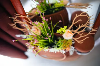 a bouquet of flowers in a brown vase at 1bedroom with Balcony facing pool Near MOA in Manila