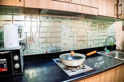 a kitchen counter with a bowl on a stove at 1bedroom with Balcony facing pool Near MOA in Manila