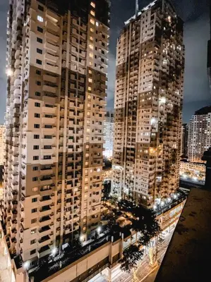 a view of two tall buildings in a city at night at Deryll's Fun house in Manila