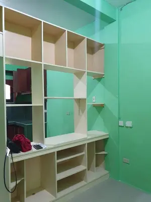 a bathroom with green walls and a glass shower at Casa Regine in Manila