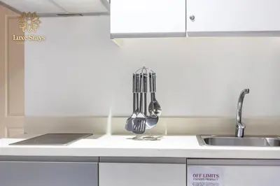 a kitchen counter with a sink and utensils at Affordable Staycation with Balcony at The Gramercy Makati in Manila