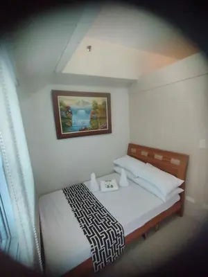 a bedroom with a bed with a picture on the wall at P3K Jazz Staycation in Manila