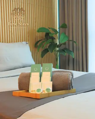 a bed with a tray with cards and a plant at Affordable 1BR Staycation at One Uptown BGC in Manila