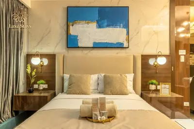 a hotel room with a bed and a painting on the wall at Luxurious 1BR Staycation at One Uptown BGC in Manila