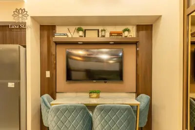 a dining room with a table and a tv at Luxurious 1BR Staycation at One Uptown BGC in Manila