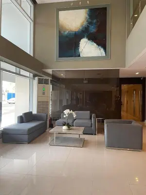 a living room with couches and a painting on the wall at Great Stay in Manila in Manila