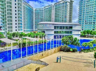 a resort with a swimming pool in front of some buildings at Dsa'sCrib 1BR Azure Near Airport in Manila