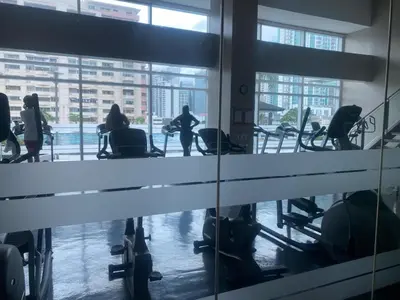 a group of people exercising in a gym at 1bedroom LOFT with Garden Terrace pool access in Manila
