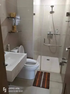 a bathroom with a shower and a toilet and a sink at Nadzcondotel - at Two Palm Tree Villas o in Manila