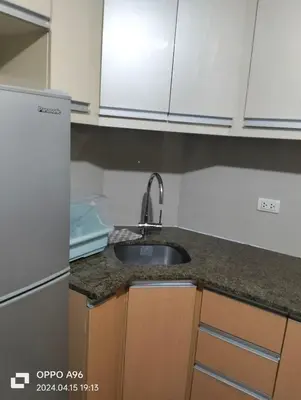 a kitchen counter with a sink and a refrigerator at Nadzcondotel - at Two Palm Tree Villas o in Manila