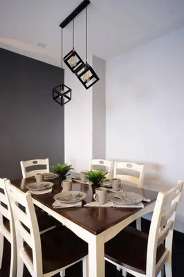 a dining room table with white chairs and a dining room at Spacious and Cozy 2 Br in The Gramercy Poblacion in Manila